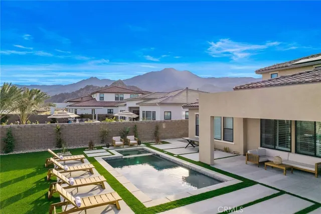 an aerial view of a house with a swimming pool