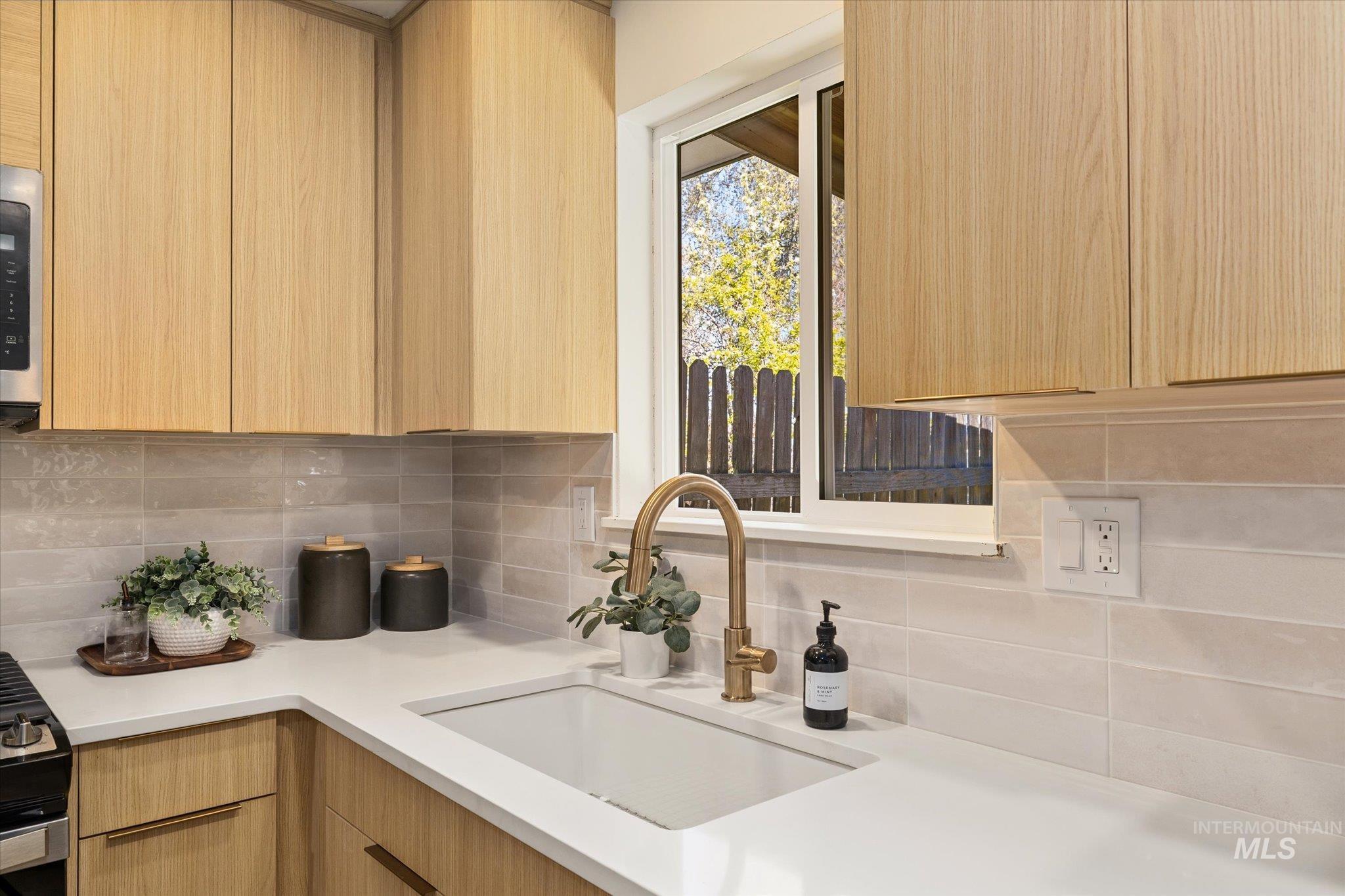 2220 Panama Street Boise, ID 83705 - Photo 12 of 27 Kitchen with light wood finish cabinetry, modern cabinets, and decorative backsplash