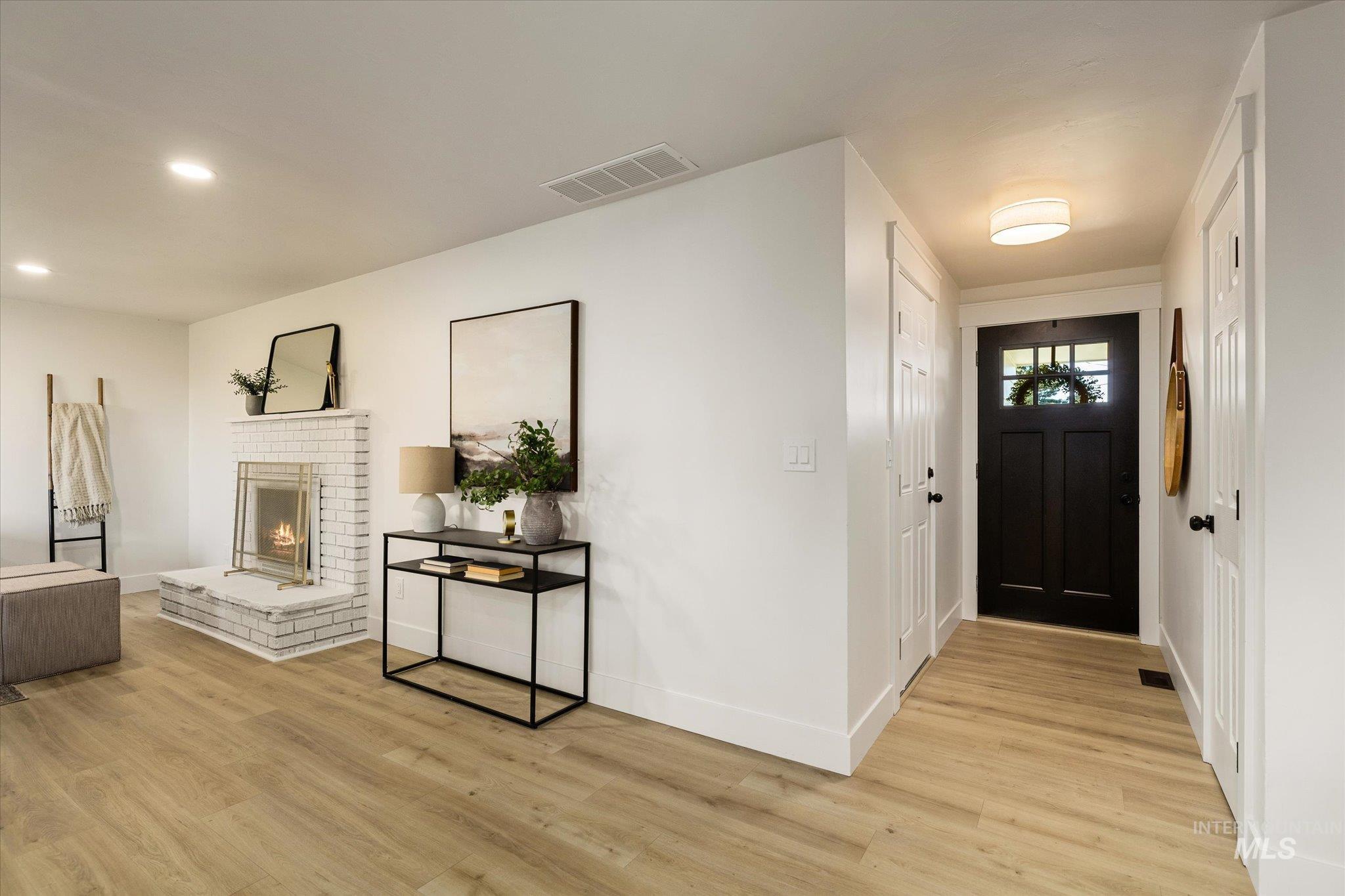 2220 Panama Street Boise, ID 83705 - Photo 4 of 27 Foyer featuring light wood-style floors, a fireplace, and recessed lighting