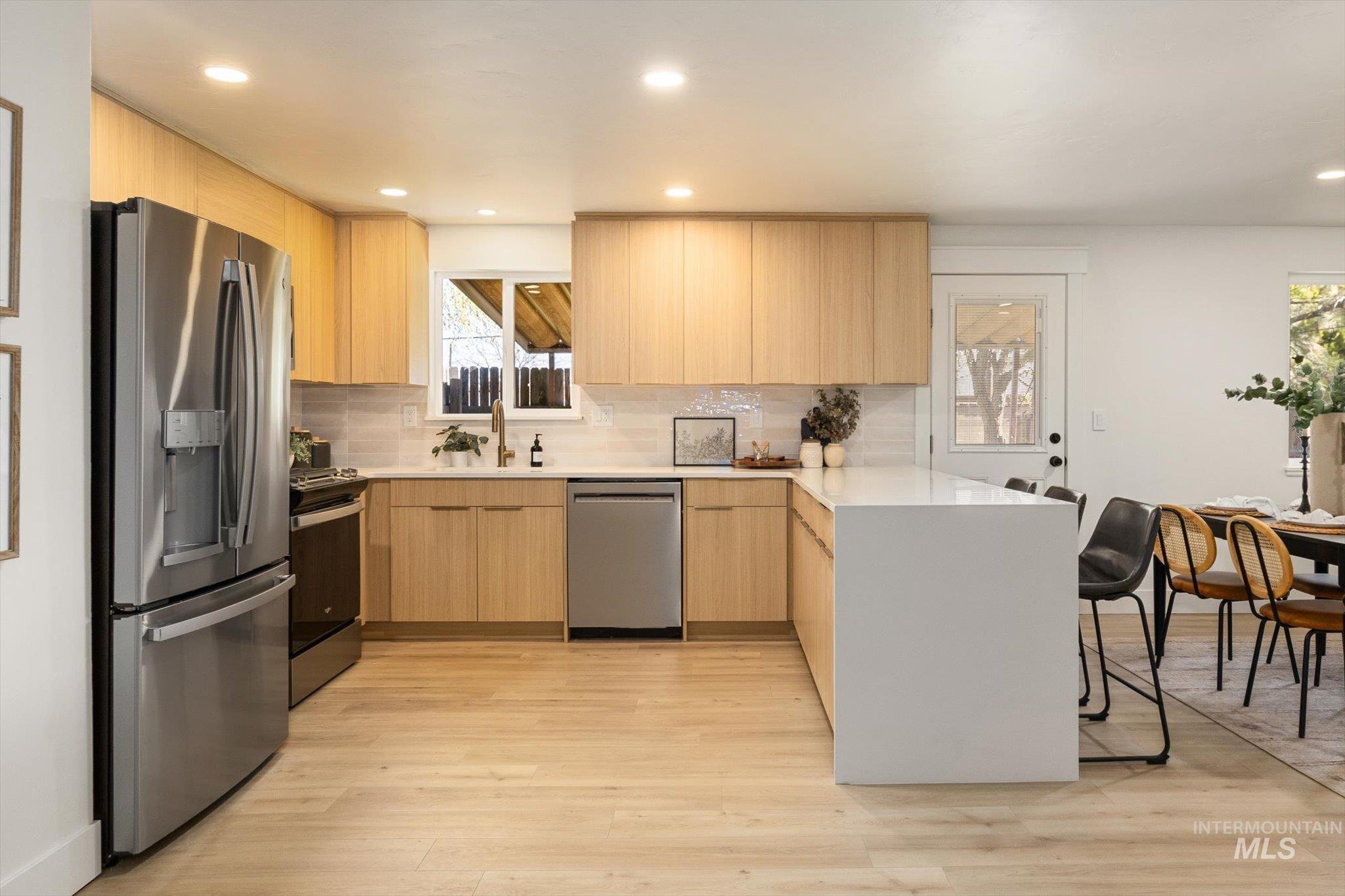 2220 Panama Street Boise, ID 83705 - Photo 10 of 27 Kitchen with a peninsula, stainless steel appliances, modern cabinets, light wood finish cabinetry, and recessed lighting