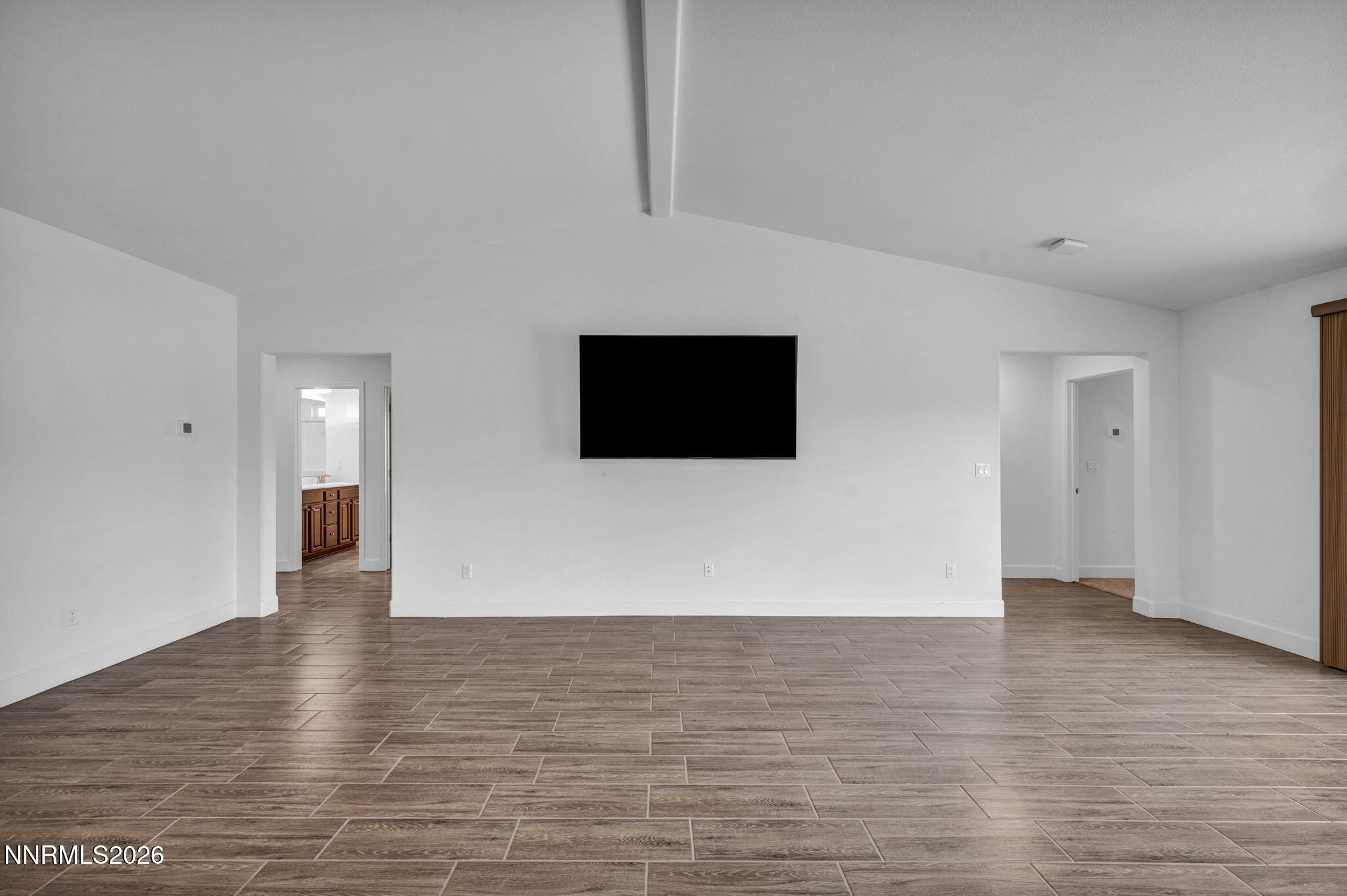 7181 Saddlehorn Road Carson City, NV 89701 - Photo 7 of 62 a view of an empty room with wooden floor
