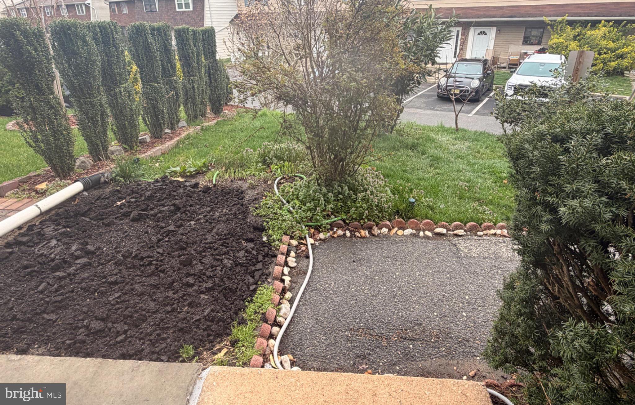 43 Via Cascata Drive Clementon, NJ 08021 - Photo 2 of 26 a view of a yard with plants and wooden fence