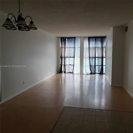 a view of an empty room with windows