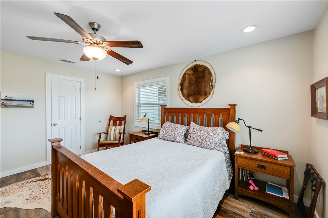 230 Cut-Off Road, Unit 101 Port Aransas, TX 78373 - Photo 18 of 30 a bedroom with bed and a chandelier