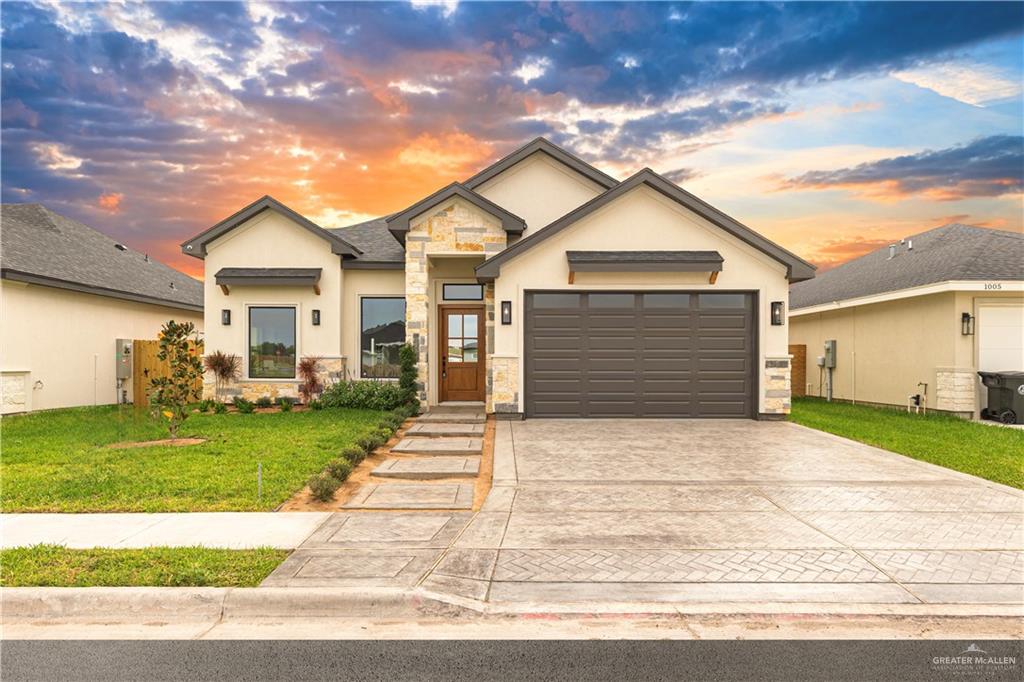 a front view of a house with a yard and garage