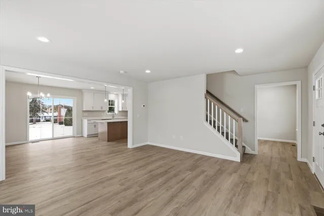 a view of a kitchen with wooden floor and a kitchen
