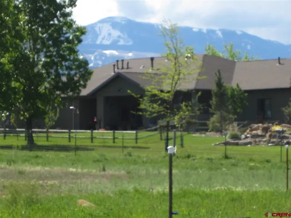 a view of a big yard with a house