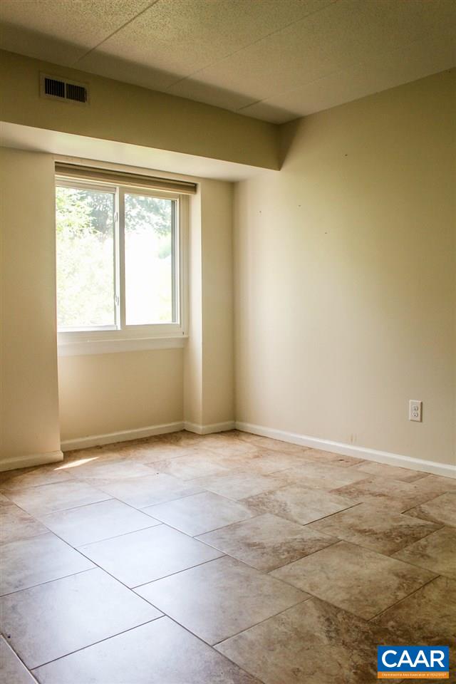 25 Spring Court Charlottesville, VA 22901 - Photo 5 of 9 an empty room with a empty space and windows