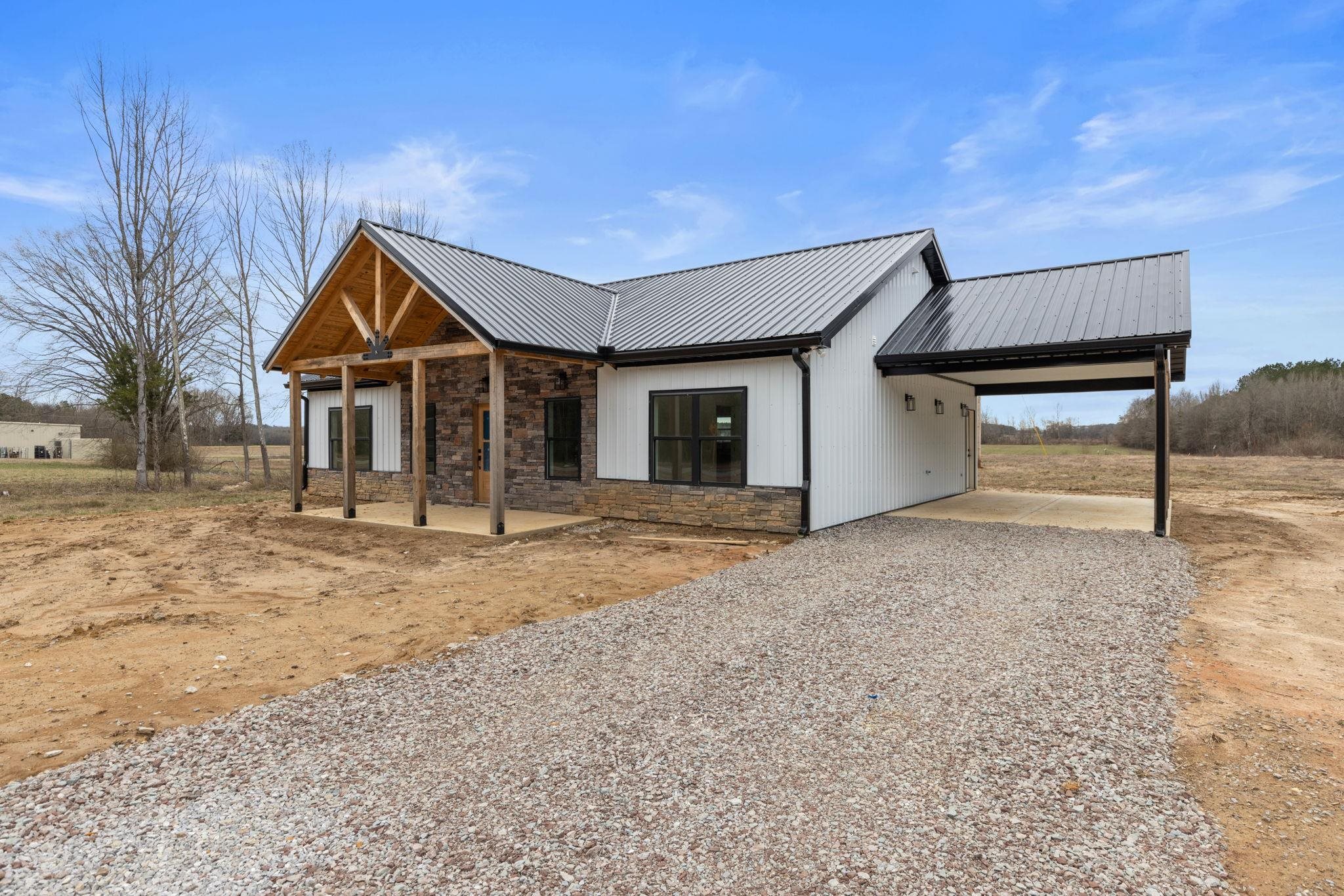460 County Road 514 Rienzi, MS 38865 - Photo 3 of 29 a house with trees in front of it