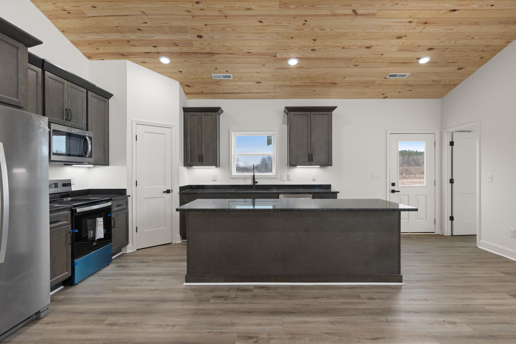 460 County Road 514 Rienzi, MS 38865 - Photo 5 of 29 a kitchen with stainless steel appliances granite countertop a stove a sink and a refrigerator