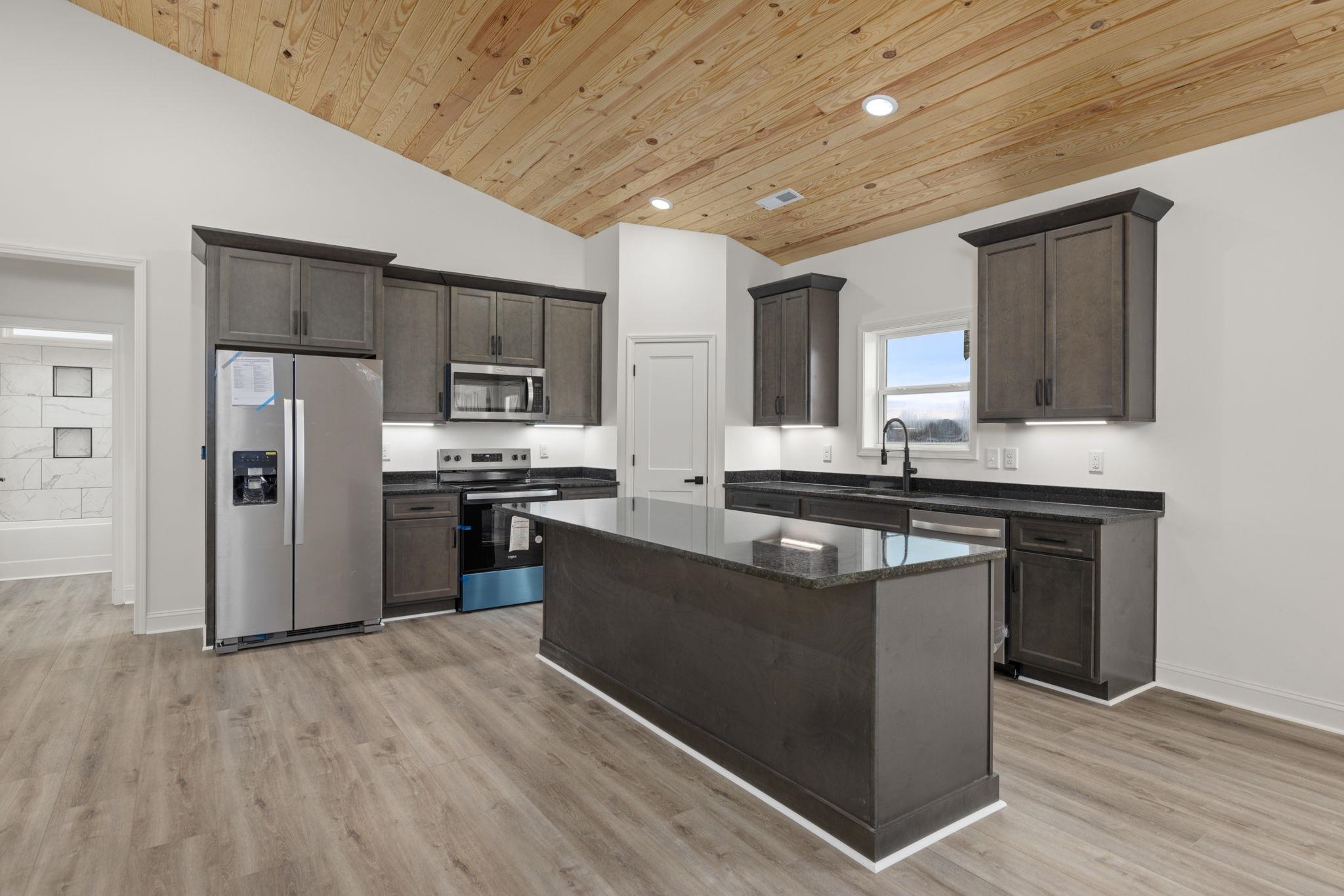 460 County Road 514 Rienzi, MS 38865 - Photo 7 of 29 a kitchen with stainless steel appliances granite countertop a refrigerator and a stove