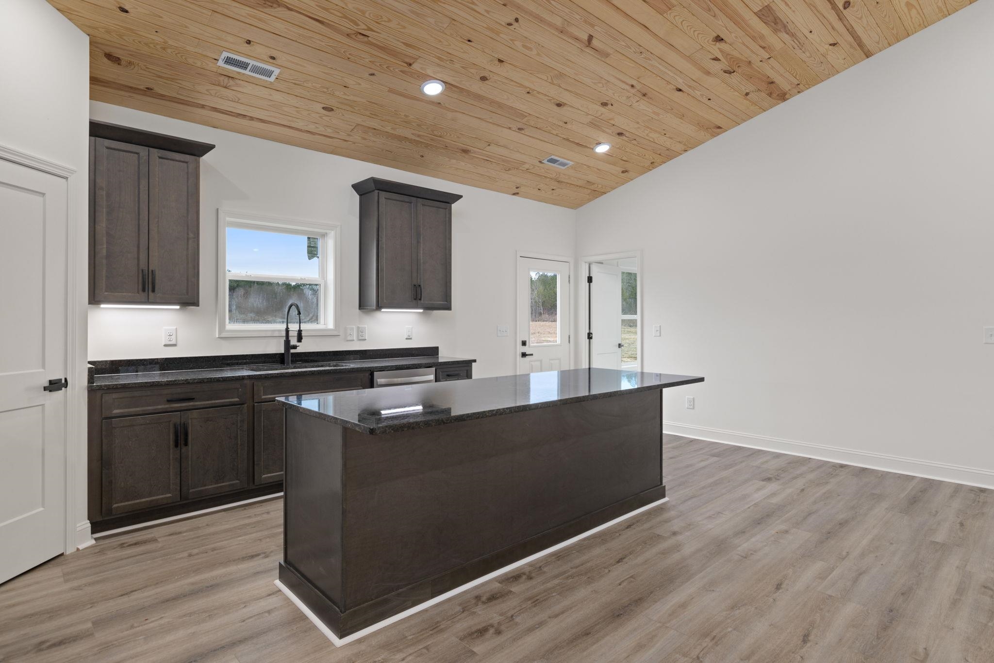 460 County Road 514 Rienzi, MS 38865 - Photo 8 of 29 a kitchen with granite countertop a sink cabinets and wooden floor