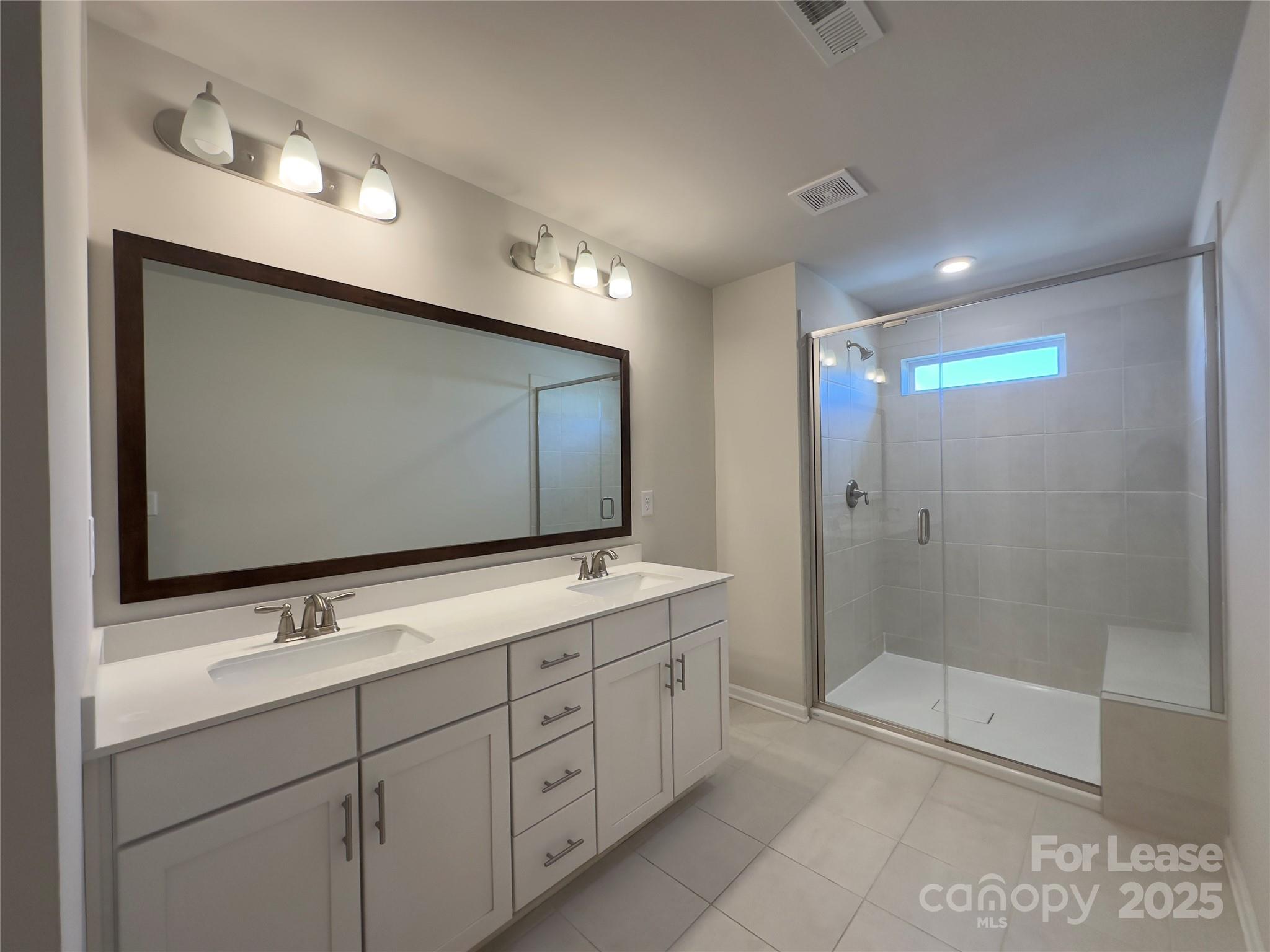 403 Wescott Street, Unit 68 Indian Trail, NC 28079 - Photo 28 of 42 a bathroom with double sink and mirror