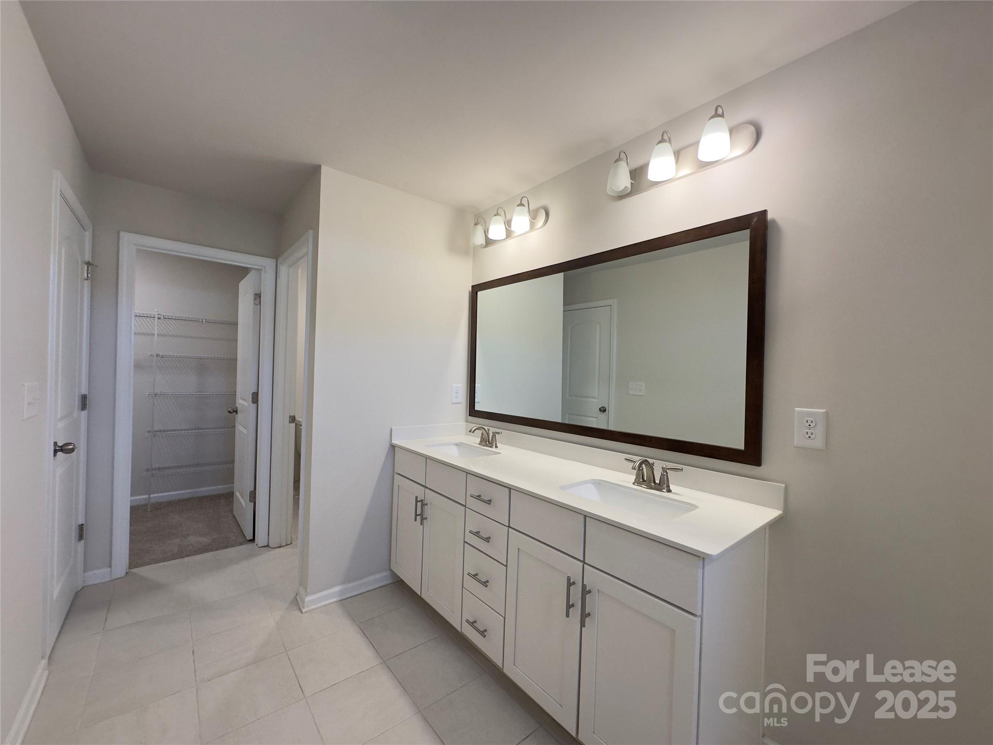 403 Wescott Street, Unit 68 Indian Trail, NC 28079 - Photo 29 of 42 a bathroom with a double vanity sink and mirror