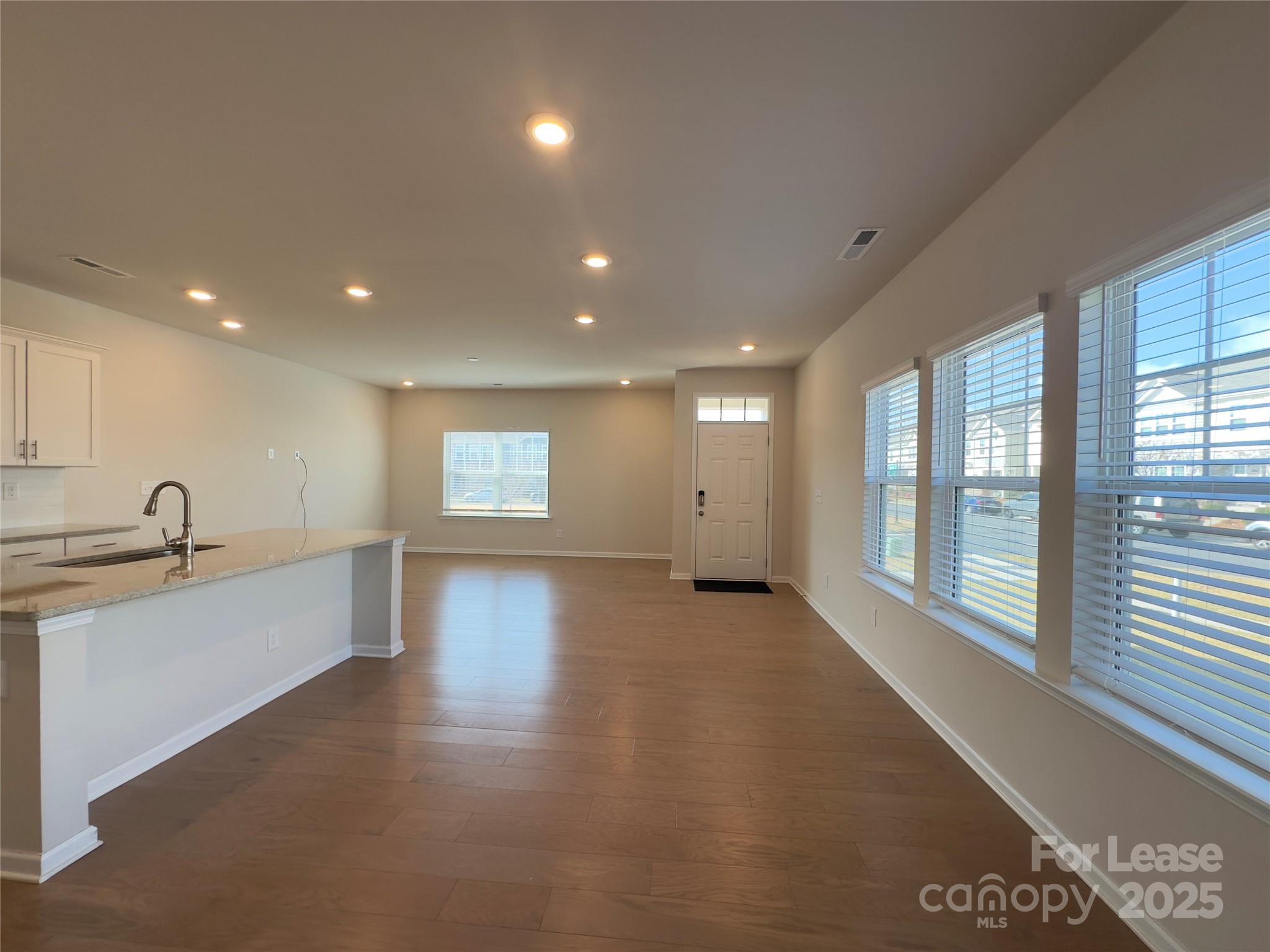 403 Wescott Street, Unit 68 Indian Trail, NC 28079 - Photo 9 of 42 a view of a big room with wooden floor and windows