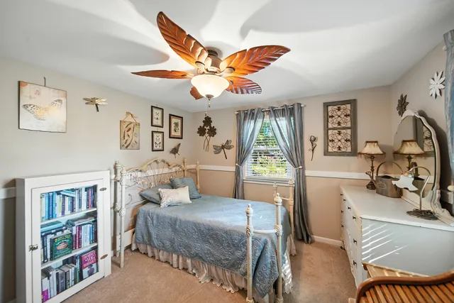 a bedroom with a bed furniture and a large window