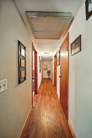 a view of a hallway with wooden floor and staircase