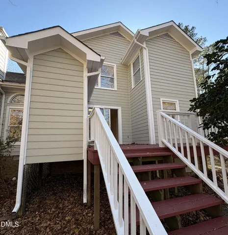 a view of a house with wooden deck