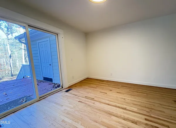 a view of room with wooden floor