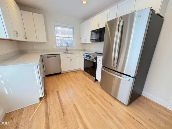 a kitchen with a refrigerator a sink and dishwasher