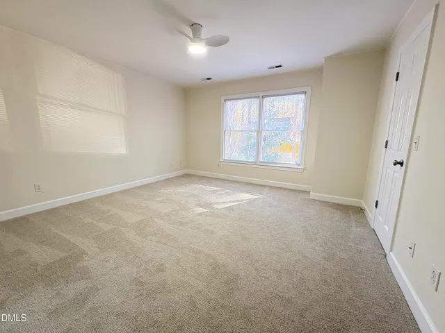 an empty room with a empty space and windows