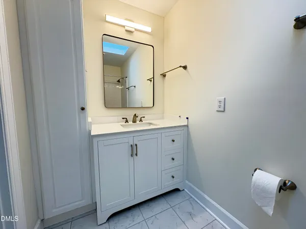 a bathroom with a double vanity sink and mirror