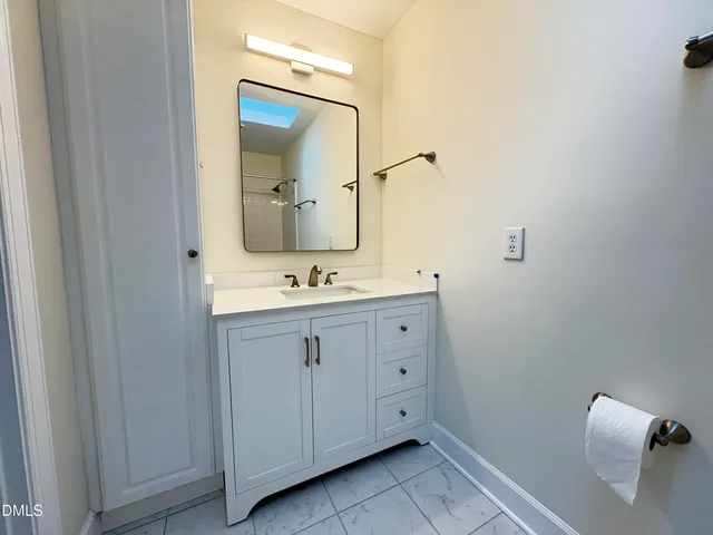 a bathroom with a double vanity sink and mirror