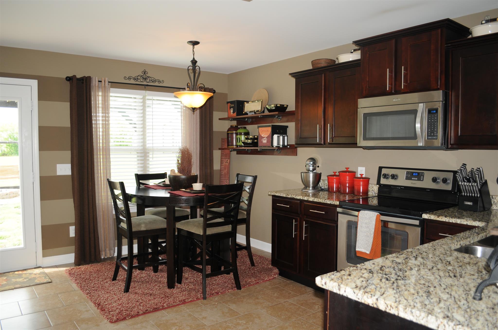 3946 C Hickory Ridge Road Lebanon, TN 37087 - Photo 5 of 16 a kitchen with a stove a sink and a dining table