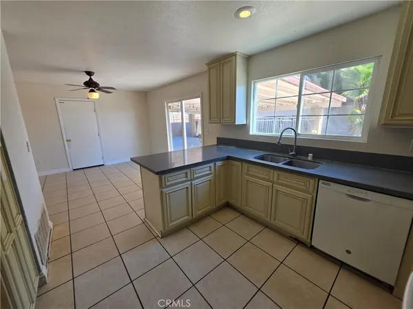 a kitchen with a sink a window and cabinets