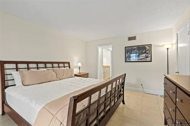 a bedroom with a large bed and a table