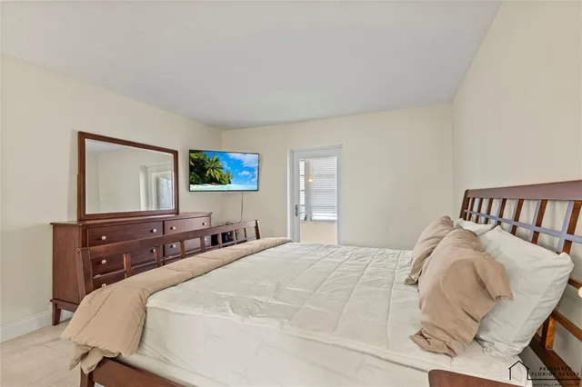 a bedroom with a bed and a tv on table