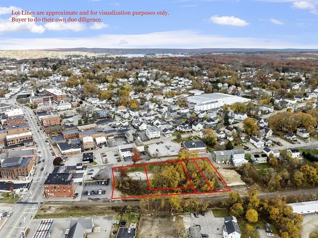 an aerial view of residential houses with city view