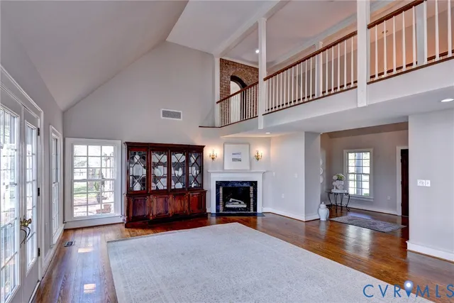 a view of an empty room fire place and a window