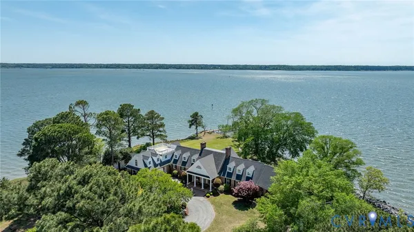 an aerial view of a house with a lake view