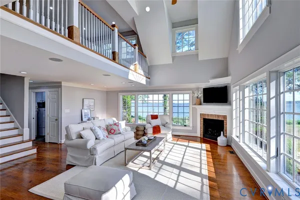 a living room with furniture fireplace and a floor to ceiling window