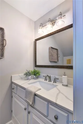 a view of a hallway with stairs and wooden floor