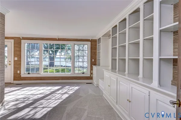 a view of staircase with railing and chandelier