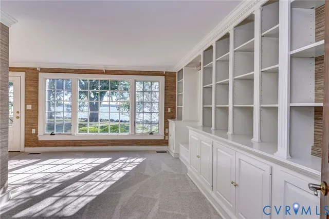 a view of staircase with railing and chandelier