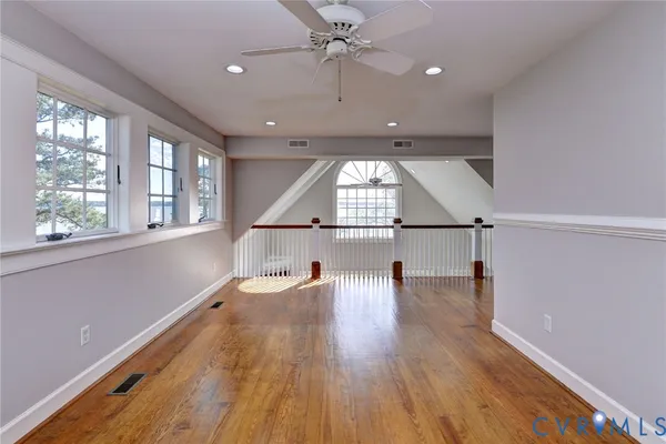 a view of a hallway to a room with windows