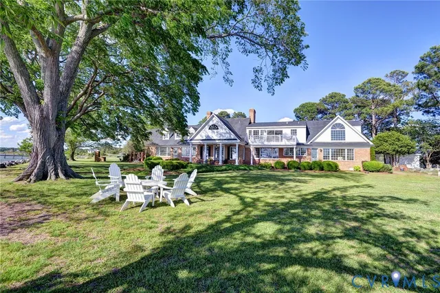 a view of a chair and table in backyard of the house