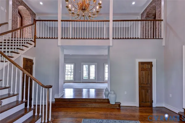 a view of an entryway with wooden floor and door