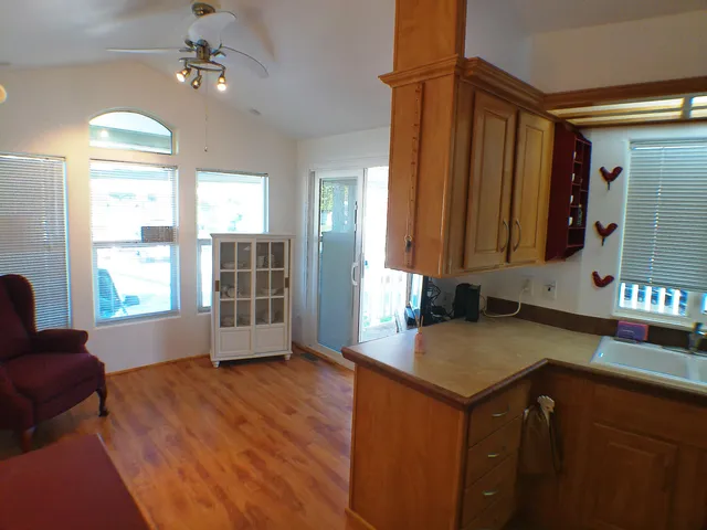 a kitchen with sink refrigerator and window