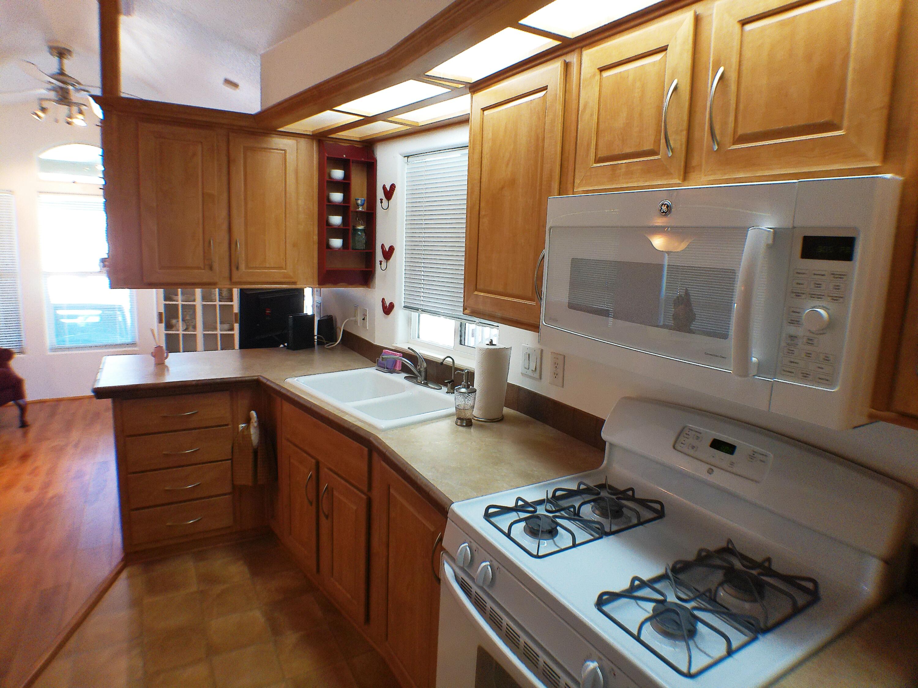 84136 Ave 44, Unit 477 Indio, CA 92203 - Photo 12 of 24 a kitchen with stainless steel appliances granite countertop a stove and a sink