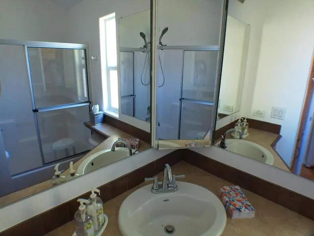 a bathroom with a double vanity sink and mirror