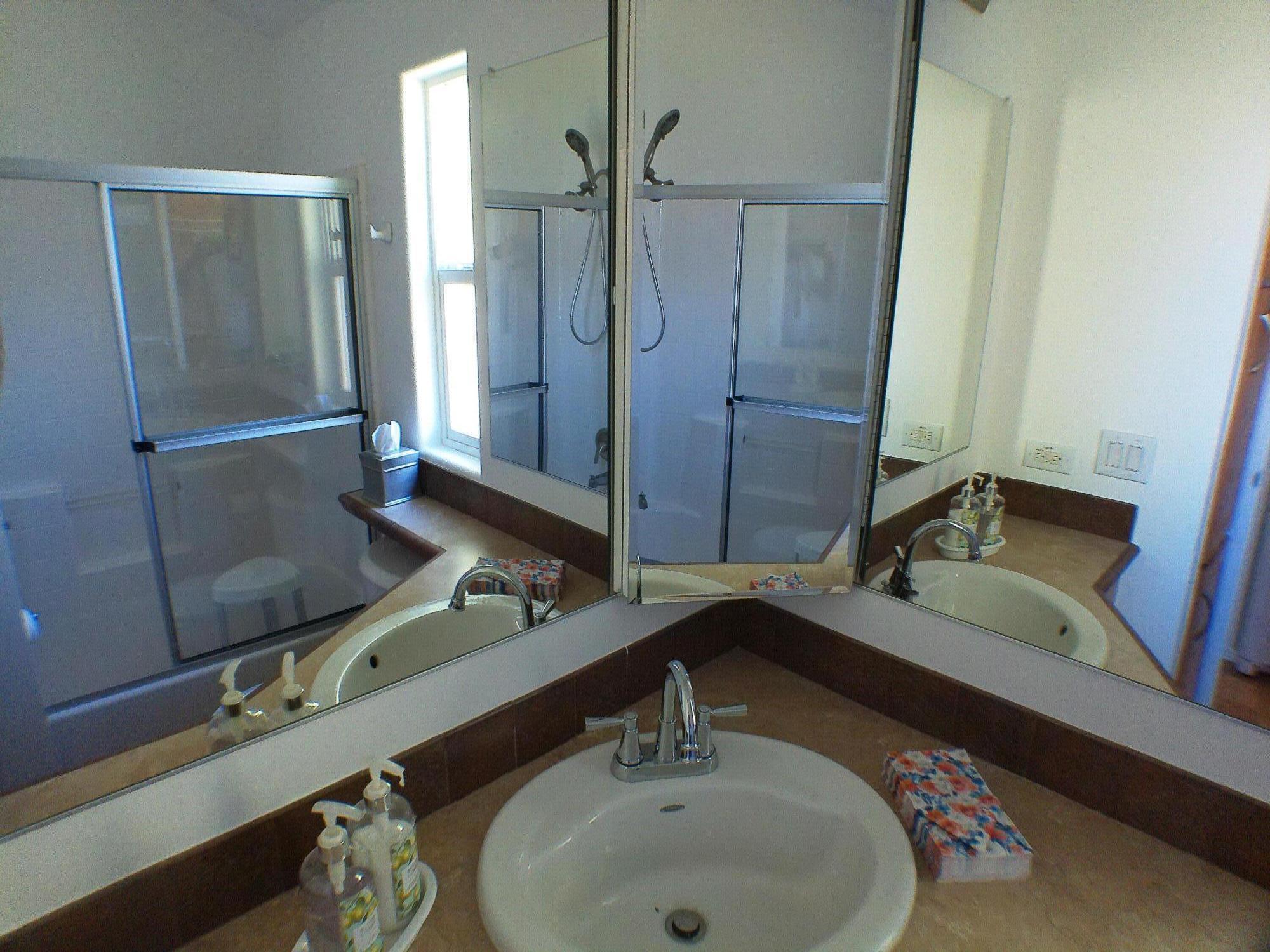 84136 Ave 44, Unit 477 Indio, CA 92203 - Photo 13 of 24 a bathroom with a double vanity sink and mirror