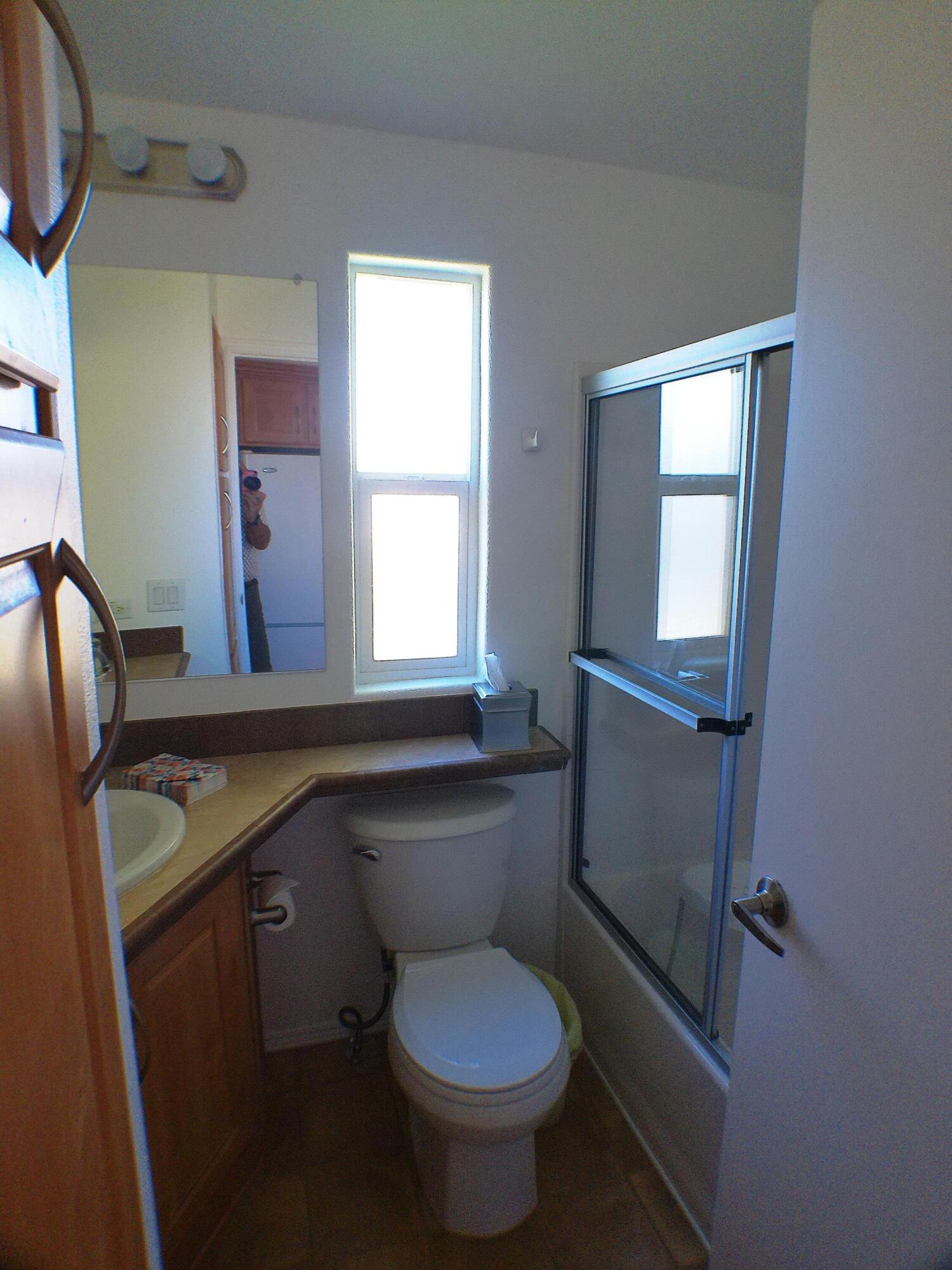84136 Ave 44, Unit 477 Indio, CA 92203 - Photo 15 of 24 a bathroom with a granite countertop toilet sink and mirror
