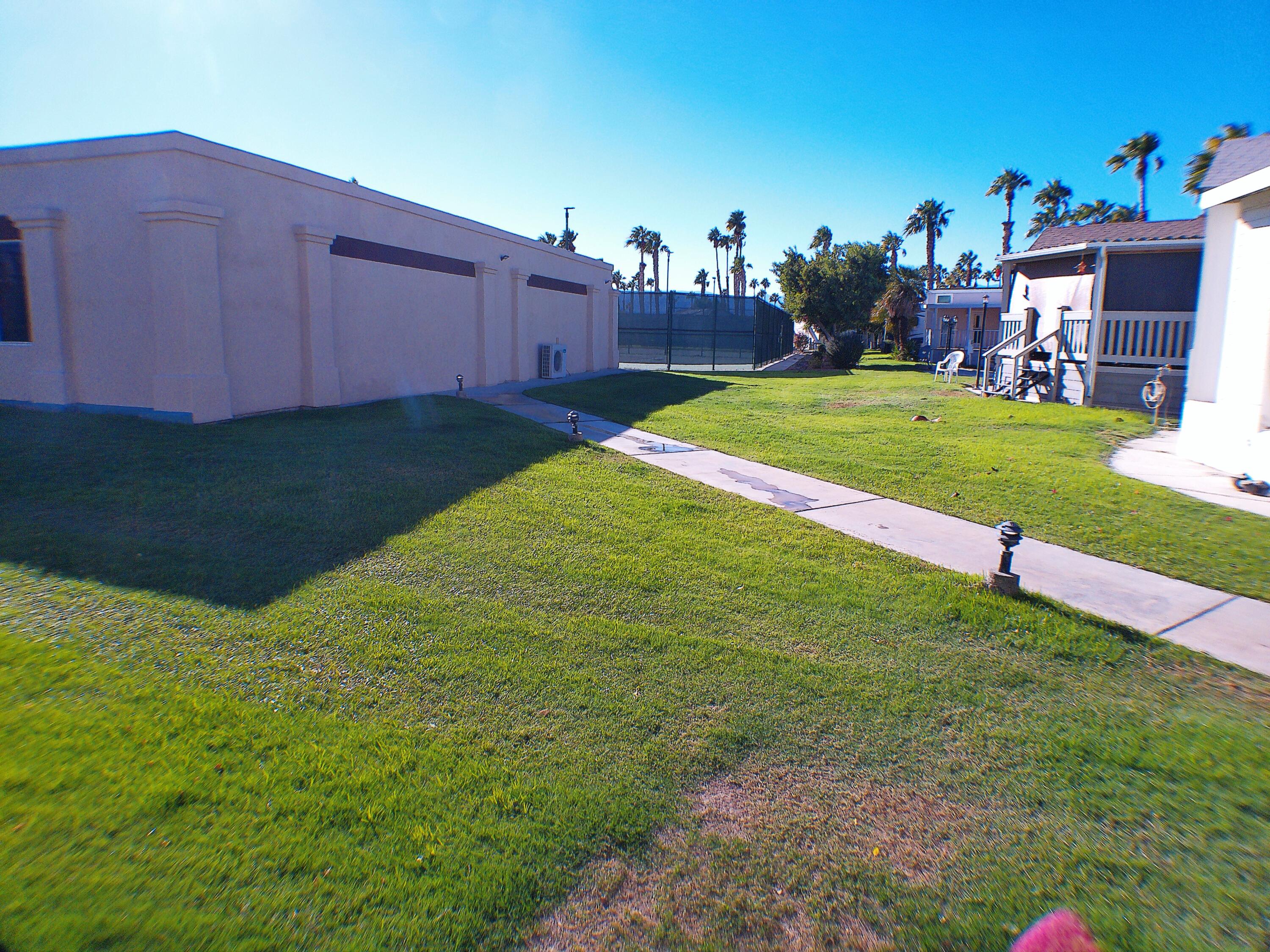 84136 Ave 44, Unit 477 Indio, CA 92203 - Photo 6 of 24 a view of a backyard with a house