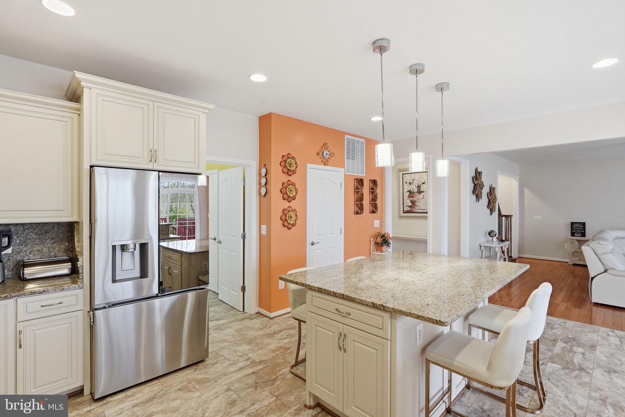 14 Smelters Trace Road Stafford, VA 22554 - Photo 16 of 78 a kitchen with stainless steel appliances granite countertop a refrigerator a sink and white cabinets