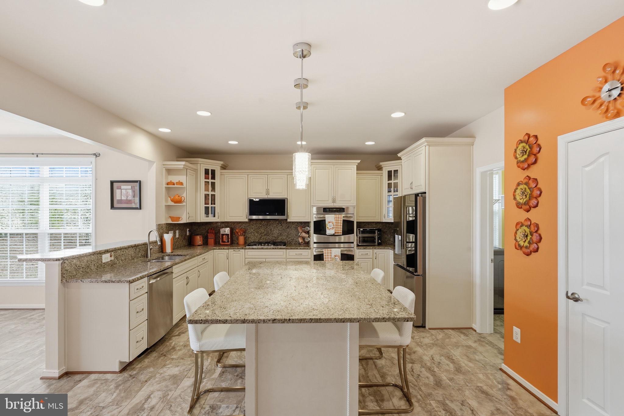 14 Smelters Trace Road Stafford, VA 22554 - Photo 20 of 78 a kitchen with stainless steel appliances granite countertop a sink a stove a refrigerator cabinets and living room view