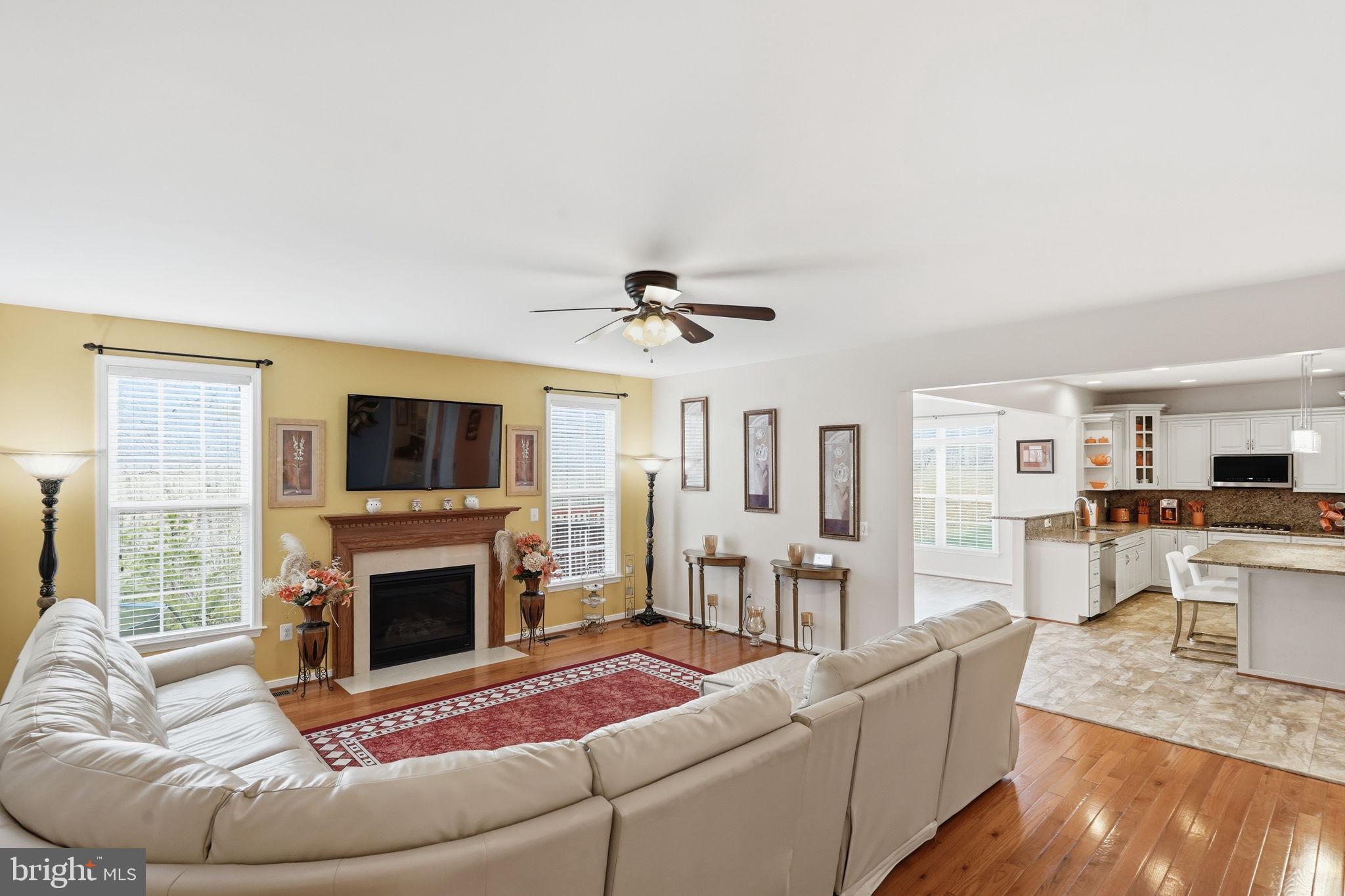 14 Smelters Trace Road Stafford, VA 22554 - Photo 22 of 78 a living room with furniture a flat screen tv and a fireplace